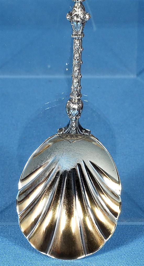 A cased set of four Victorian silver parcel gilt fruit serving spoons and a sugar sifter, spoon 197mm, weight 12.4oz/388 grms.